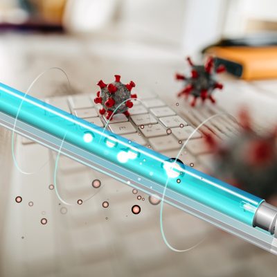 Close up model of corona virus on desk and keyboard in office